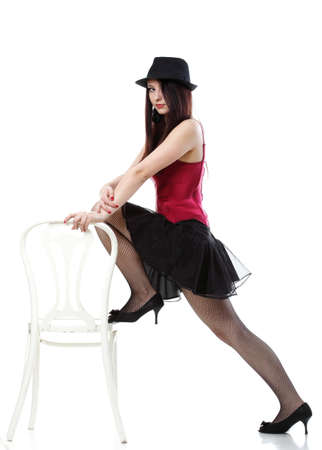 entertainment pastime girl dance in red corset chair white isolated showgirl,の写真素材