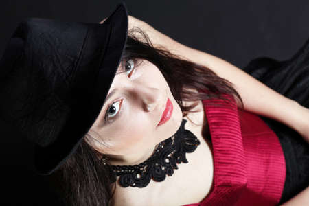 Portrait woman in red corset showgirl black backgroundの写真素材