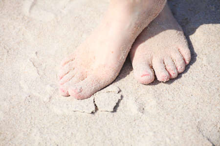 nice legs pedicure red nail sand beachの写真素材