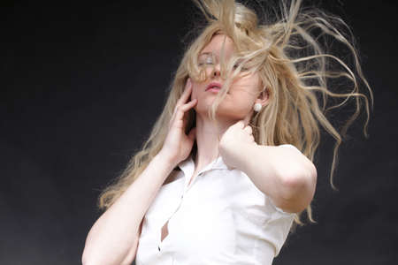 Blonde woman with her hair blowing in the windの写真素材