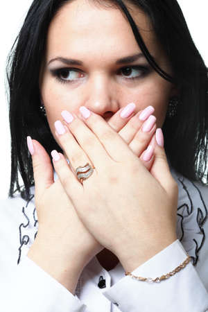 discreet awkward meaningful silence pretty woman with hands over mouthの写真素材