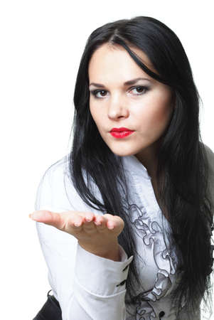 beautiful young brunette woman blowing a kissの写真素材