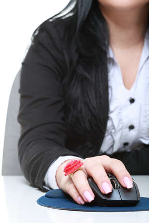 Woman hand with computer mouse on a white backgroundの写真素材