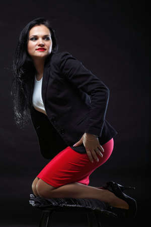 portrait of beautiful young brunette on black background.の写真素材