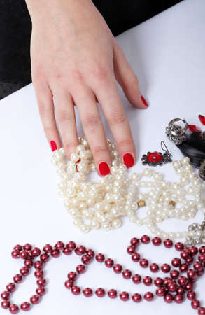 woman hands a red and white bead tableの写真素材