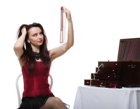 entertainment pastime girl dance in red corset chair white isolated showgirl jeweleryの写真素材