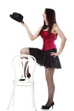 entertainment pastime girl dance in red corset chair white isolated showgirl,の写真素材