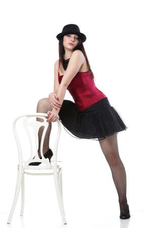 entertainment pastime girl dance in red corset chair white isolated showgirl,の写真素材