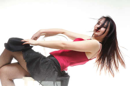 entertainment pastime girl dance in red corset chair white isolated showgirl,の写真素材
