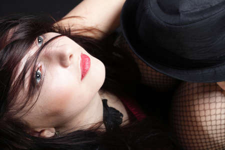 Portrait woman in red corset showgirl black backgroundの写真素材