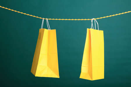 Shopping yellow gift bags on green backgroundの写真素材