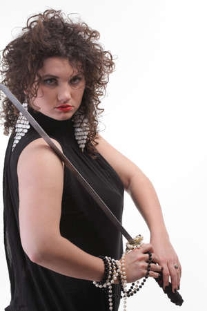 Girl - woman dark curly hair natural brown-haired holding hands katana swordの写真素材