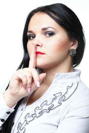Young woman brunette girl asking for silence white isolatedの写真素材