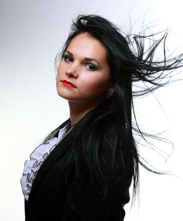 beautiful woman with long hair posing isolated on whiteの写真素材