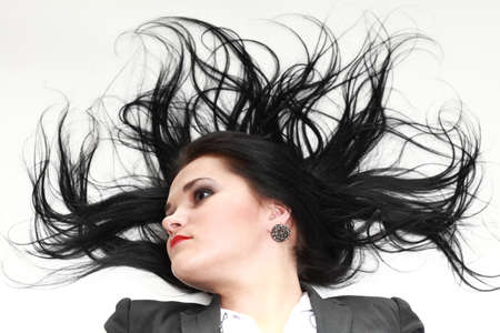 beautiful woman with long hair posing isolated on whiteの写真素材