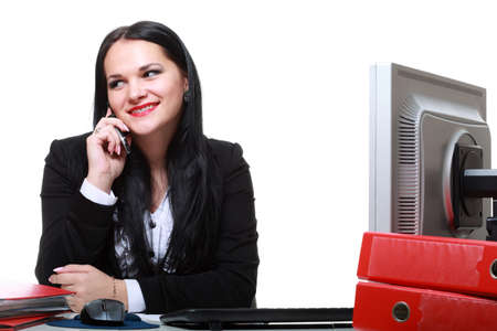 modern business woman talking phone sitting at office deskの写真素材