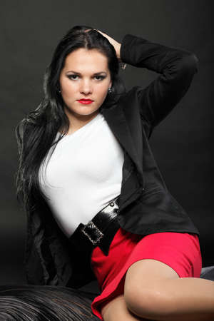 portrait of beautiful young brunette on black background.の写真素材
