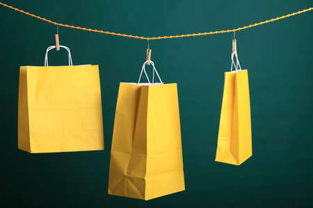 Shopping yellow gift bags on green backgroundの写真素材