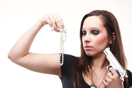 Sexy young woman with a gun and pearl isolated on whiteの写真素材