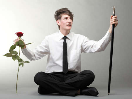 Portrait of a young man grey background. Love and rose.の写真素材