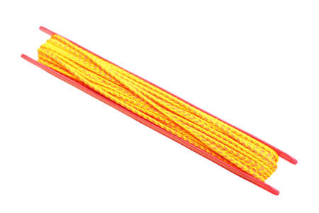 yellow string roll up isolated on whiteの写真素材