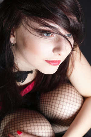 Portrait woman in red corset showgirl black backgroundの写真素材