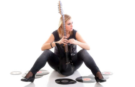 Woman with guitar listening to music - isolated over a white background analogue recordの写真素材