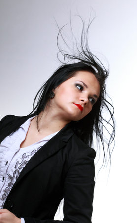 beautiful woman with long hair posing isolated on whiteの写真素材