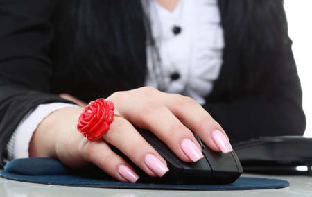 Woman hand with computer mouse on a white backgroundの写真素材