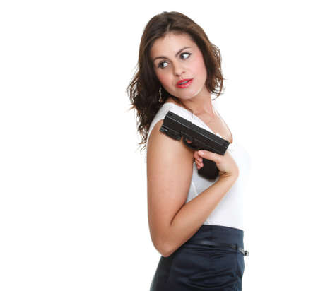 Young brunette woman with gun isolated on whiteの写真素材