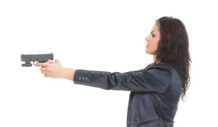 Young brunette woman with gun isolated on whiteの写真素材