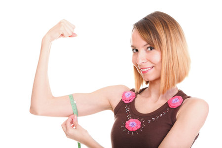 Fitness woman jumping excited isolated on white background image of beautiful multiracial Caucasian...