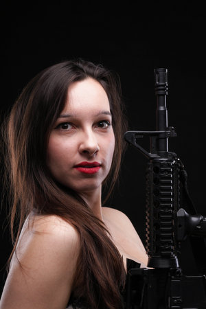 Sexy women - Girl holding an Assault Rifle, black background