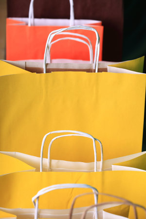 Shopping yellow gift bags on green background