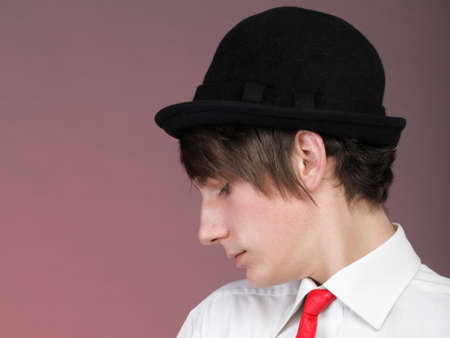 Young men with the red rose on colour background. Love and reflection.の写真素材