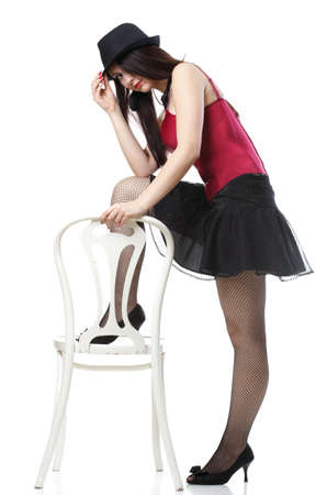 entertainment pastime girl dance in red corset chair white isolated showgirl,の写真素材