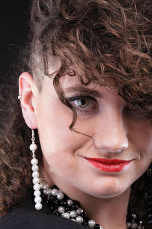 Girl - Ear super piercing woman dark hair natural brown-haired black backgroundの写真素材