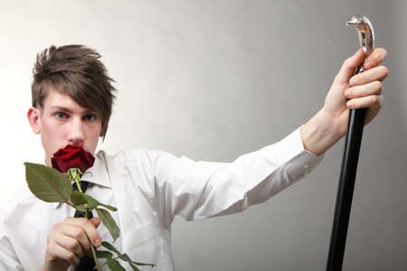 Portrait of a young man grey background. Love and rose.の写真素材