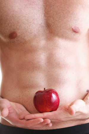 Muscle sexy wet naked young man torso and red apple in hands diet