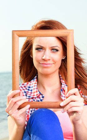 Woman sea sky vacation Holding Frame travel conceptの写真素材