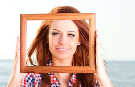 Woman sea sky vacation Holding Frame travel conceptの写真素材