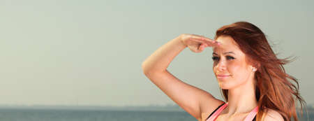 Attractive girl Young woman looking on background of skyの写真素材