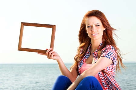 Woman sea sky vacation Holding Frame travel conceptの写真素材