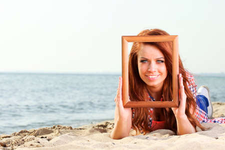 Woman sea sky vacation Holding Frame travel conceptの写真素材
