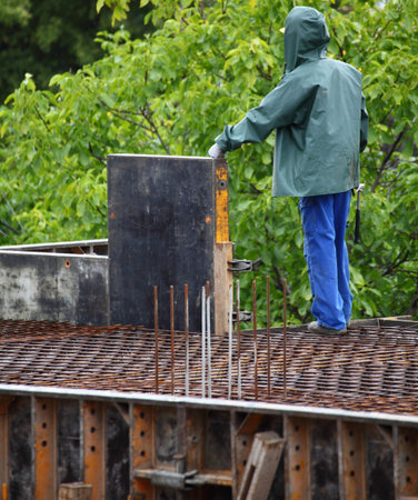 construction site with worker working planks metal wall