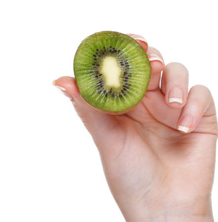 woman hand with kiwi fruit isolated on whiteの写真素材