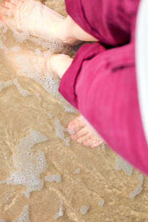 nice legs in water, nice pedicure red nail sand beachの写真素材
