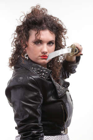 Girl - woman dark curly hair natural brown-haired holding in her hands a katanaの写真素材