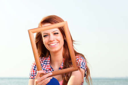 Woman sea sky vacation Holding Frame travel conceptの写真素材