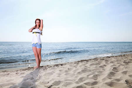 The young happy woman on a beach sea and sky vacationの写真素材